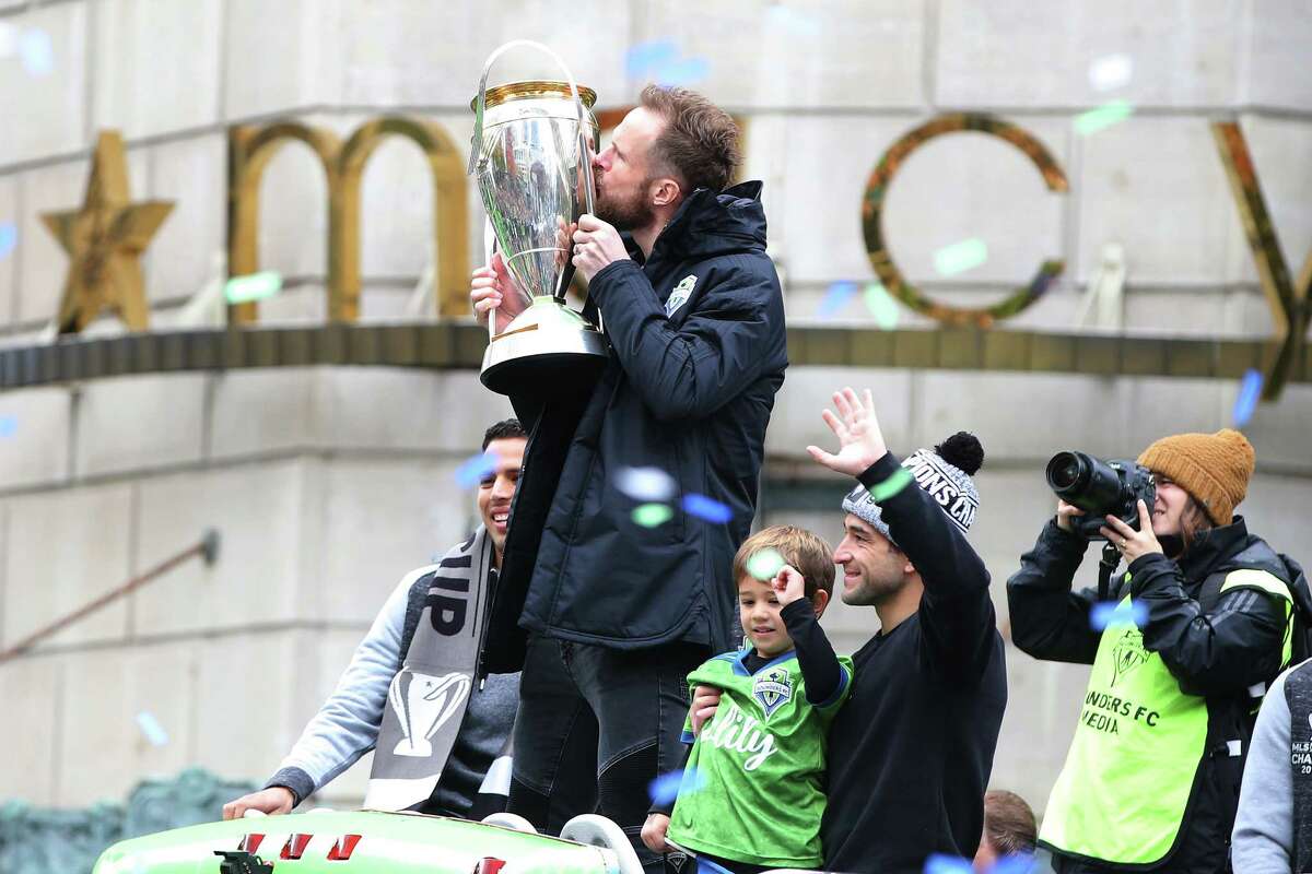 Seattle Sounders goalkeeper Stefan Frei kisses the Philip F. Anschutz trophy as the city celebrates the Sounders' MLS Cup Championship win with a parade from Westlake Park to Seattle Center and a rally, Tuesday, Nov. 12, 2019. The Sounders beat Toronto 3-1 to bring home their second MLS Cup in four years.