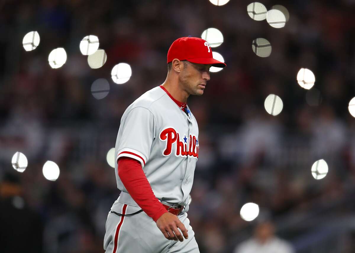 Philadelphia Phillies manager Gabe Kapler returns to the dugout after a pitching change in the sixth inning of a baseball game against the Atlanta Braves, Saturday, March 31, 2018, in Atlanta. (AP Photo/Todd Kirkland)