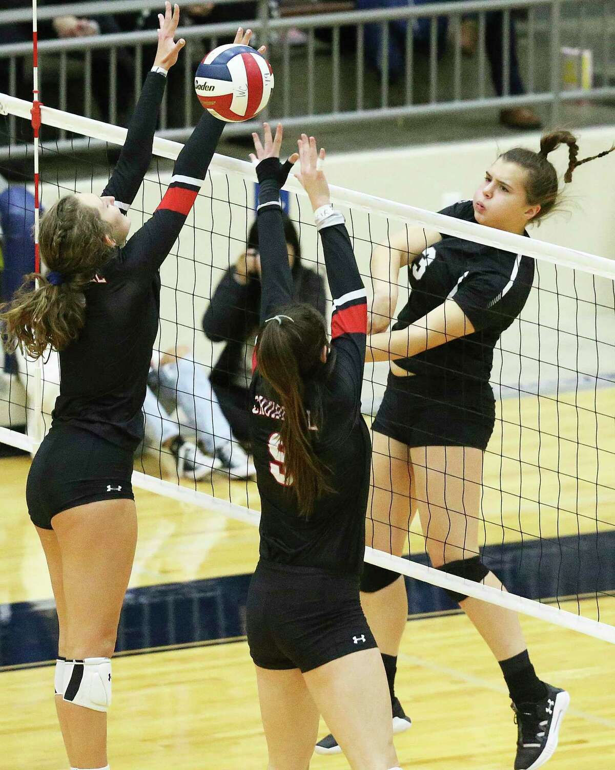 Clark hitter Mackenzie Wolff gets the ball over defenders as Clark plays Churchill in 6A third round volleyball playoff action at the Alamo Convocation Center on Nov. 12, 2019.