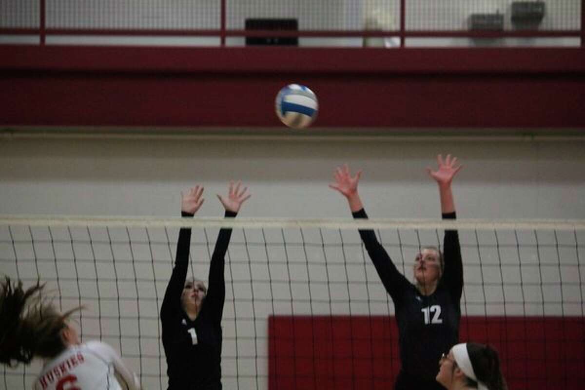 Reed City's Demi Lodholtz (1) and Alison Duddles go after the ball against Benzie Central in district action last week. (Herald Review photo/John Raffel)