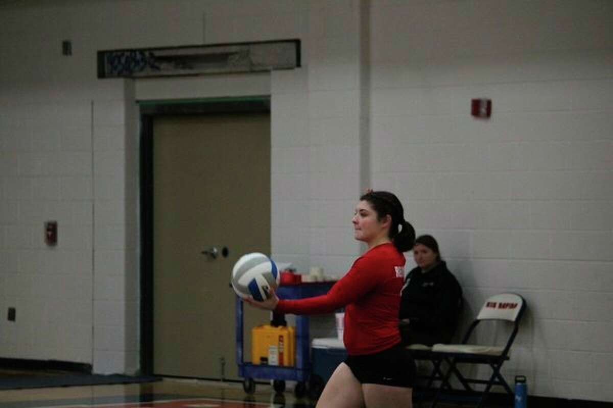 Maddie Morgan gets ready to make a serve in district action last week. (Pioneer photo/John Raffel)
