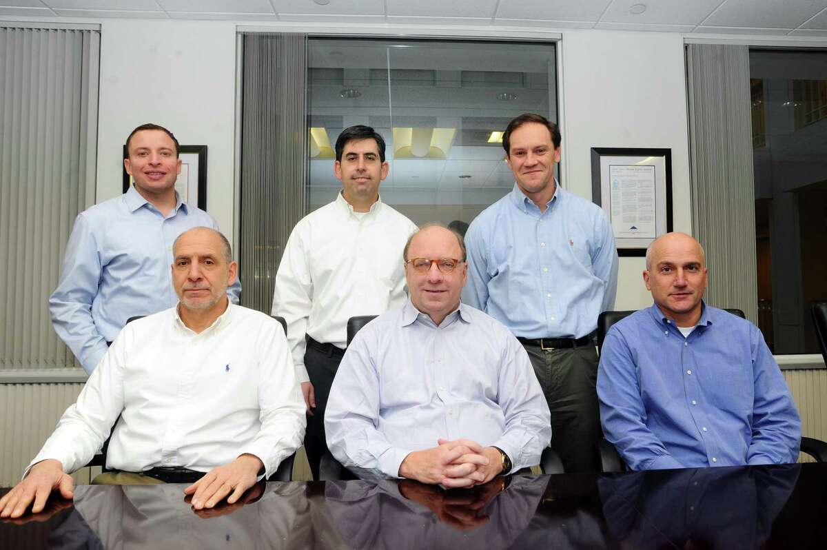 Several of private equity firm Olympus Partners’ partners gather in the firm’s Station Place offices in Stamford, Conn., on Dec. 19, 2017. From left, are: partner Jason Miller, managing partner Lou Mischianti, partner Evan Eason, founder and managing partner Rob Morris, partner David Haddad and partner Paul Rubin.
