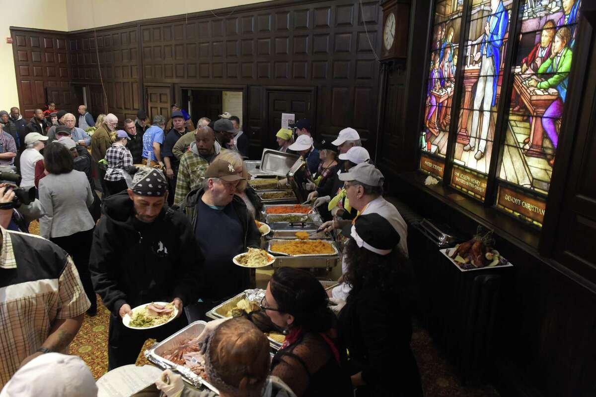 Volunteers serve food at the 48th Annual Equinox Thanksgiving Community Dinner on Thursday, Nov. 23, 2017, in Albany, N.Y. (Paul Buckowski / Times Union)
