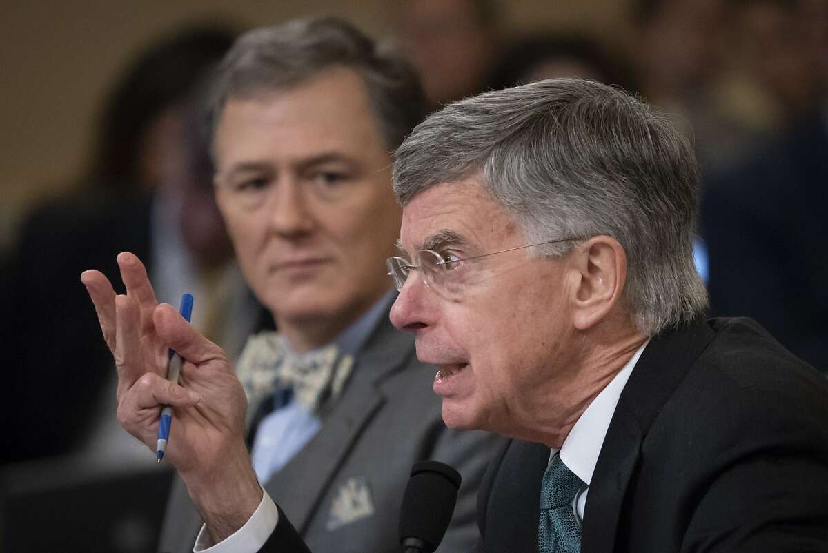 The top U.S. diplomat in Ukraine William Taylor, center, and career Foreign Service officer George Kent, left, testify before the House Intelligence Committee on Capitol Hill in Washington, Wednesday, Nov. 13, 2019, during the first public impeachment hearings of President Donald Trump's efforts to tie U.S. aid for Ukraine to investigations of his political opponents. (AP Photo/J. Scott Applewhite)
