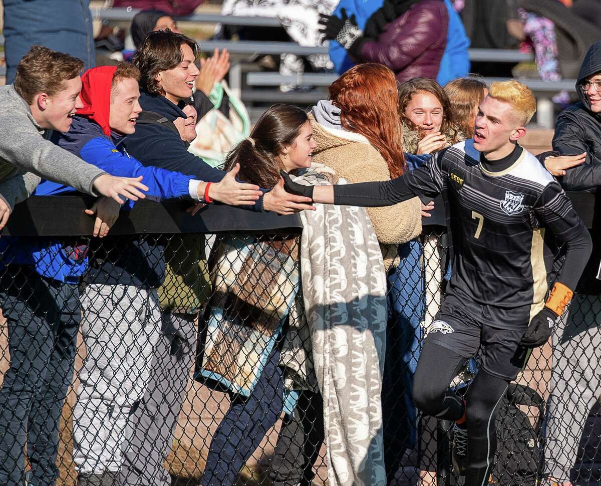 Matt Bagley gets some love from Trumbull fans after he scored his second goal in Trumbull's 6-1 victory over Shelton. Trumbull High’s Matthew Bagley celebrates with the fans after his first goal against Shelton high in the second round of the CIAC CLass LL Boys Soccer State Tournament, Wednesday, November 13, 2019, at Trumbull High School.