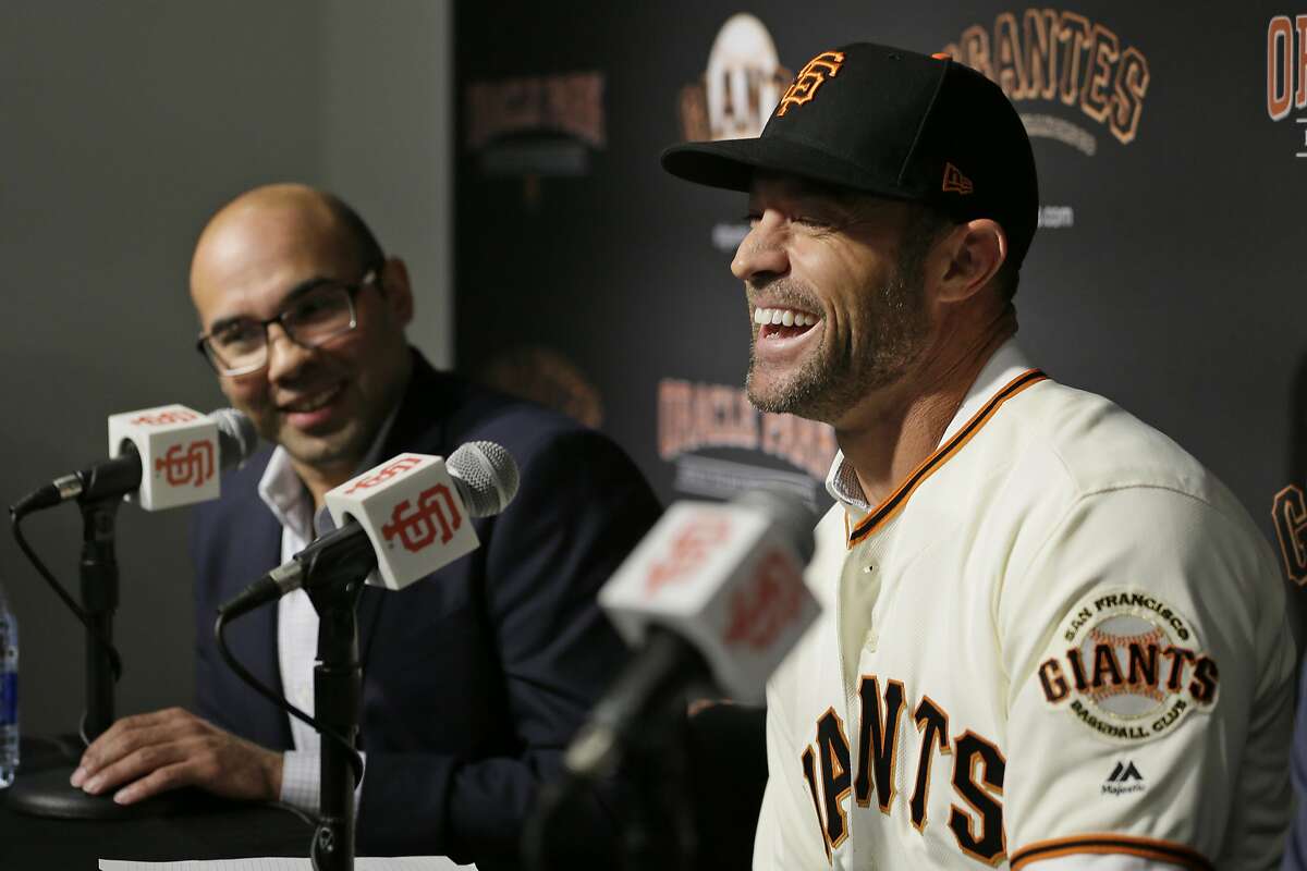 San Francisco Giants manager Gabe Kapler, right, laughs during a news conference as president of baseball operations Farhan Zaidi looks on at Oracle Park Wednesday, Nov. 13, 2019, in San Francisco. Gabe Kapler has been hired as manager of the San Francisco Giants, a month after being fired from the same job by the Philadelphia Phillies. Kapler replaces Bruce Bochy, who retired at the end of the season following 13 years and three championships with San Francisco. (AP Photo/Eric Risberg)