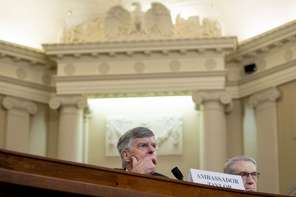 Top U.S. diplomat in Ukraine William Taylor, center, appears before the House Intelligence Committee on Capitol Hill in Washington, Wednesday, Nov. 13, 2019, during the first public impeachment hearing of President Donald Trump's efforts to tie U.S. aid for Ukraine to investigations of his political opponents. (AP Photo/Andrew Harnik)