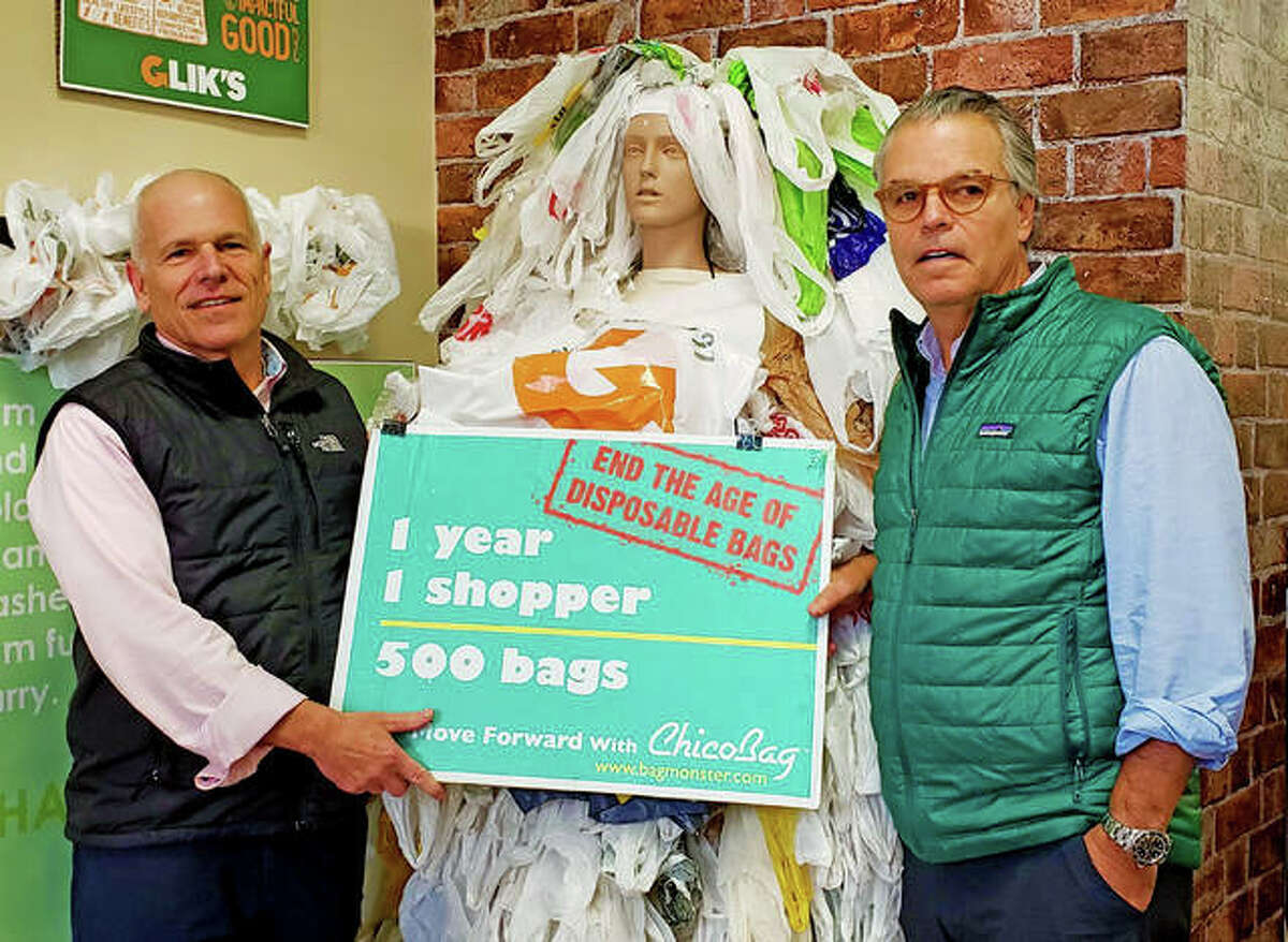 Jeff, left) and Jim Glik stand next to the bag monster sculpture in the recently made selfie room at their Edwardsville location.