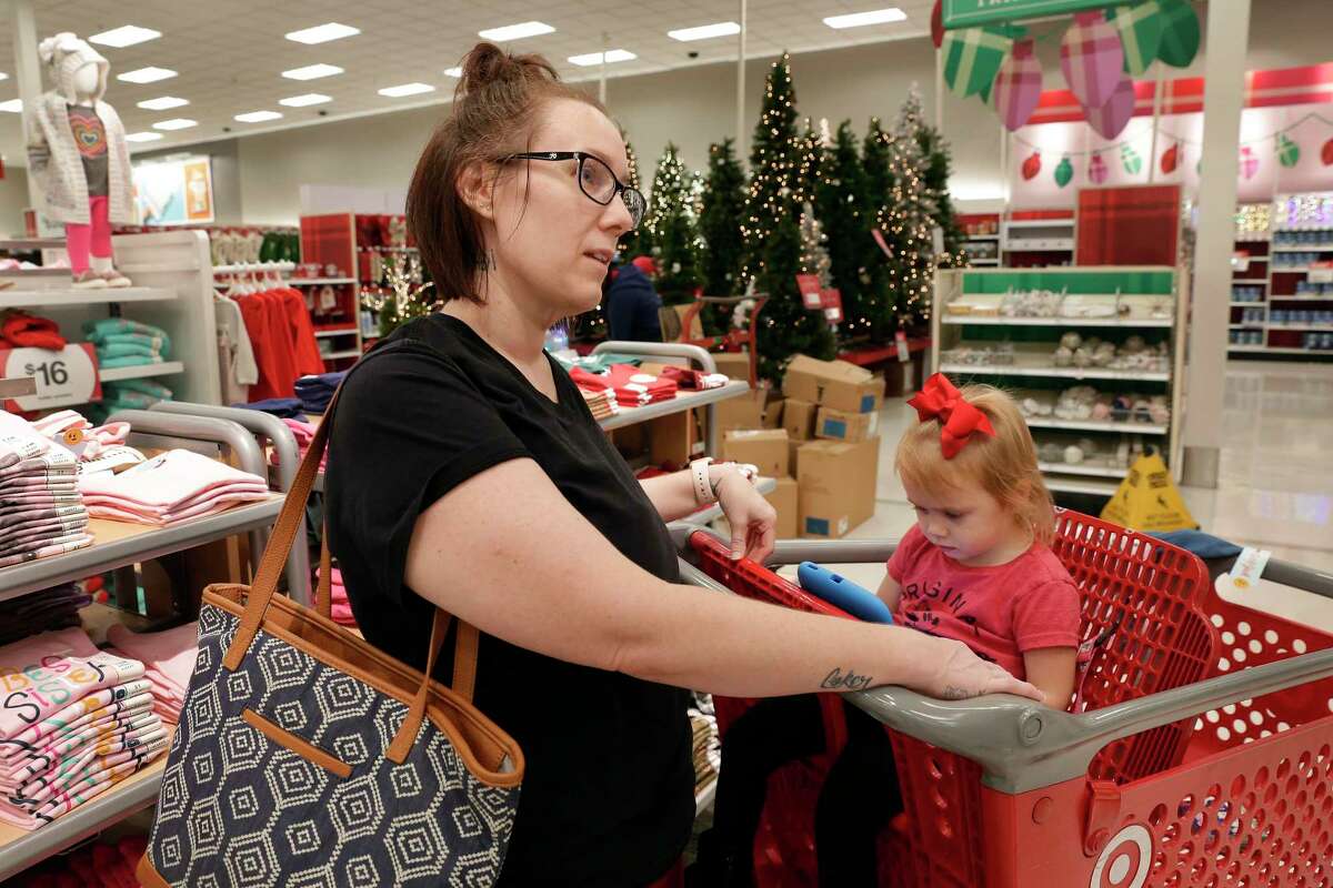 Blair Minnis and her daughter Brynleigh Coker, age two, shop for Christmas items at the Disney Store within a store in the Target store Monday, Nov. 11, 2019 in Spring, TX.