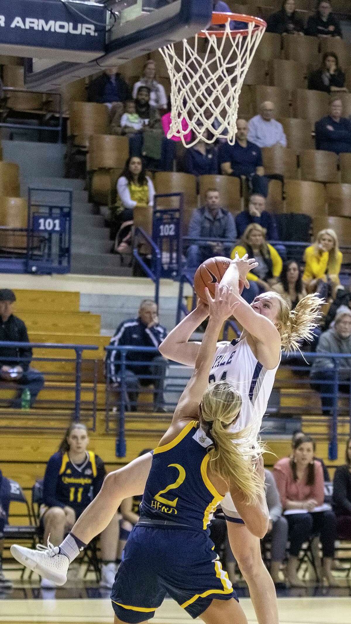 Yale guard Ellen Margaret Andrews draws a foul from Quinnipiac’s Taylor Herd during the first half in 2019.