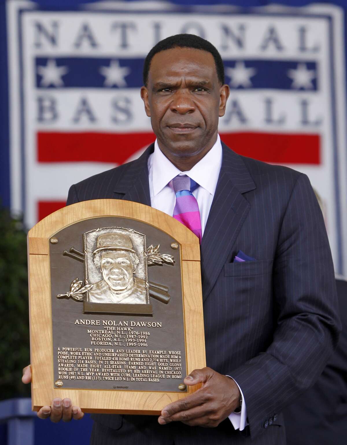 Andre Dawson poses with his plaque after his induction to the Baseball Hall of Fame in Cooperstown, N.Y., on Sunday, July 25, 2010. (AP Photo/Mike Groll)
