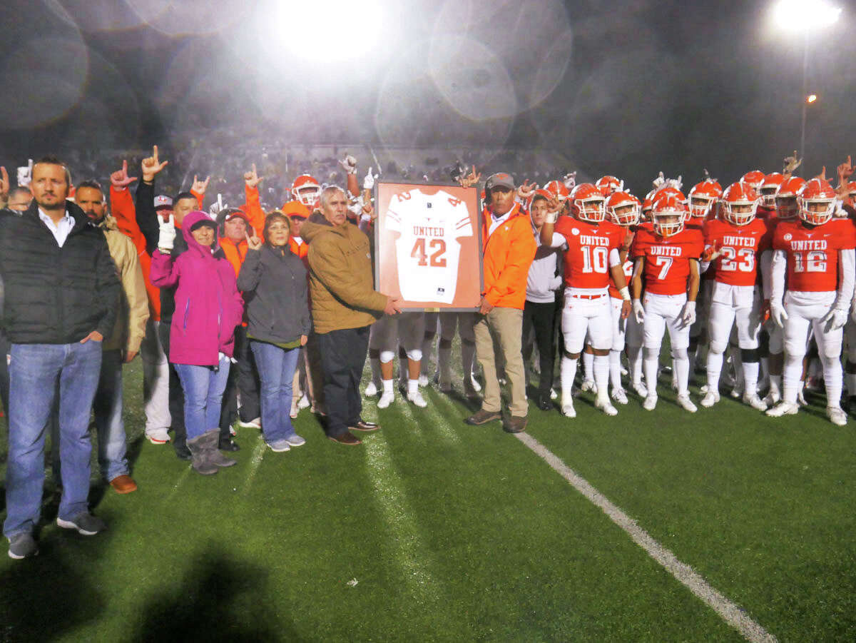 United High School players, coaches and administrators retire the jersey of United High School football player Jalen Garcia during halftime of the United versus Alexander football game, November, 7, 2019 at the United ISD SAC.