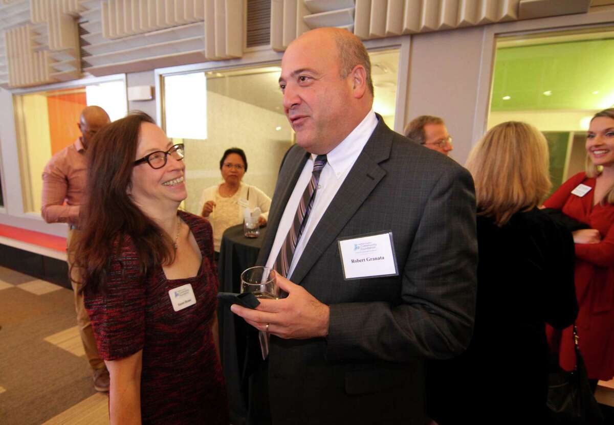 Fairfield County's Community Foundation's Karen Brown chats with colleague Robert Granata during the celebratration of the 10th anniversary of its Center for Nonprofit Excellence at at the Westport Public Library in Westport, Conn., on Wednesday Nov. 13, 2019.
