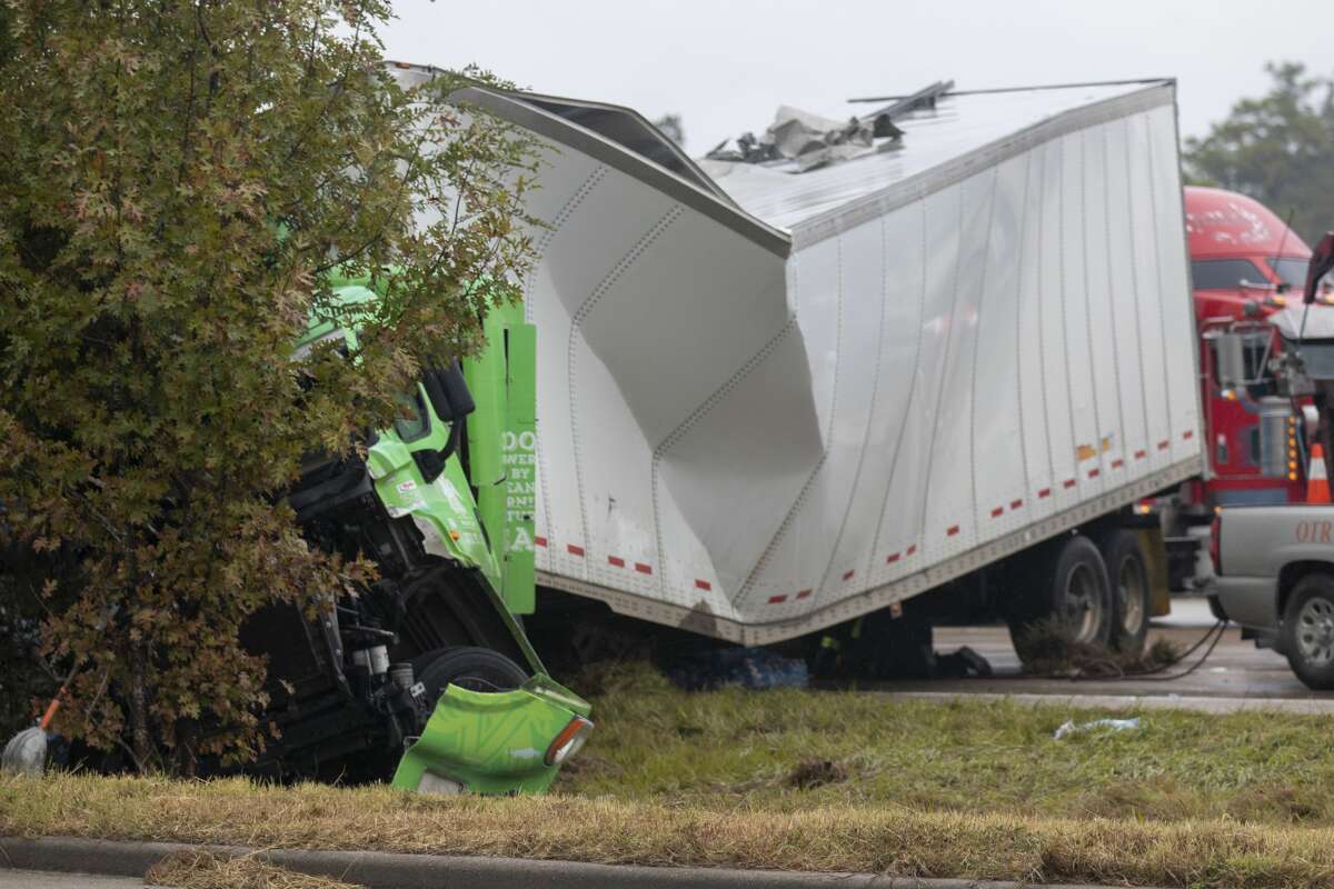 The front end of a wrecked 18-wheeler is seen Thursday, November 14, 2019 on Interstate 45 near Lake Woodlands Drive in The Woodlands. The truck slammed into the back of a stalled Greyhound bus early Thursday injuring several people.