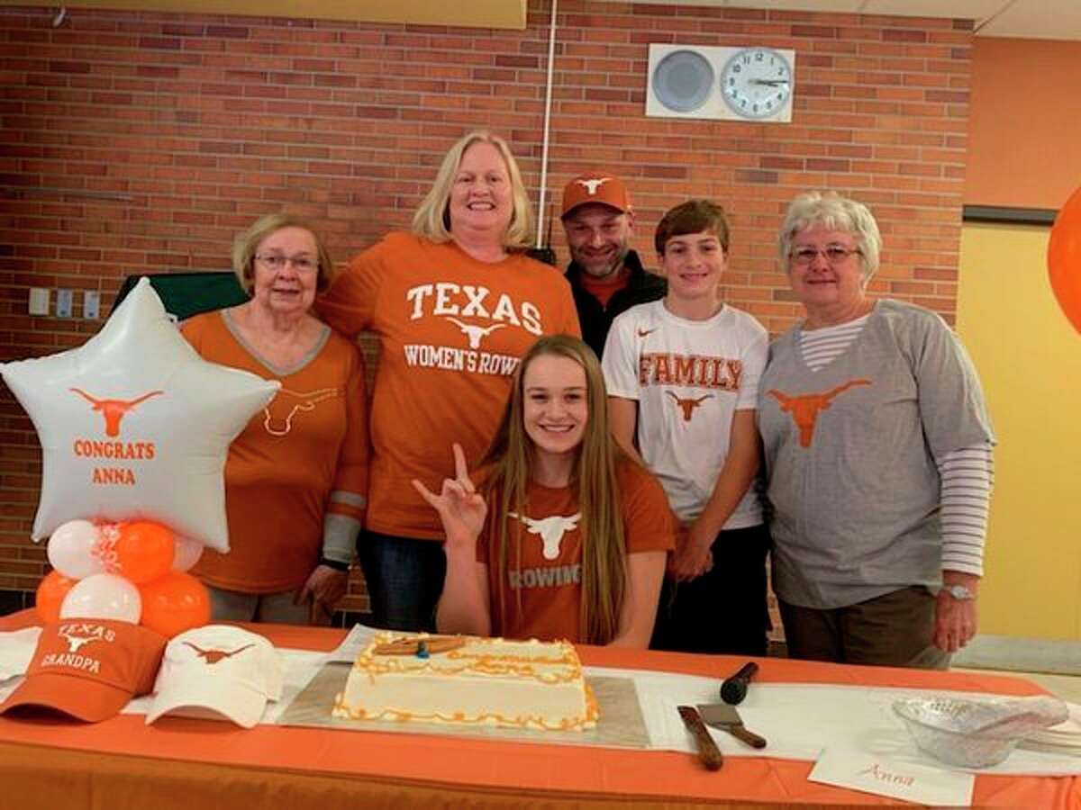 Dow High's Anna Jensen is joined by her family after signing with the University of Texas rowing program.