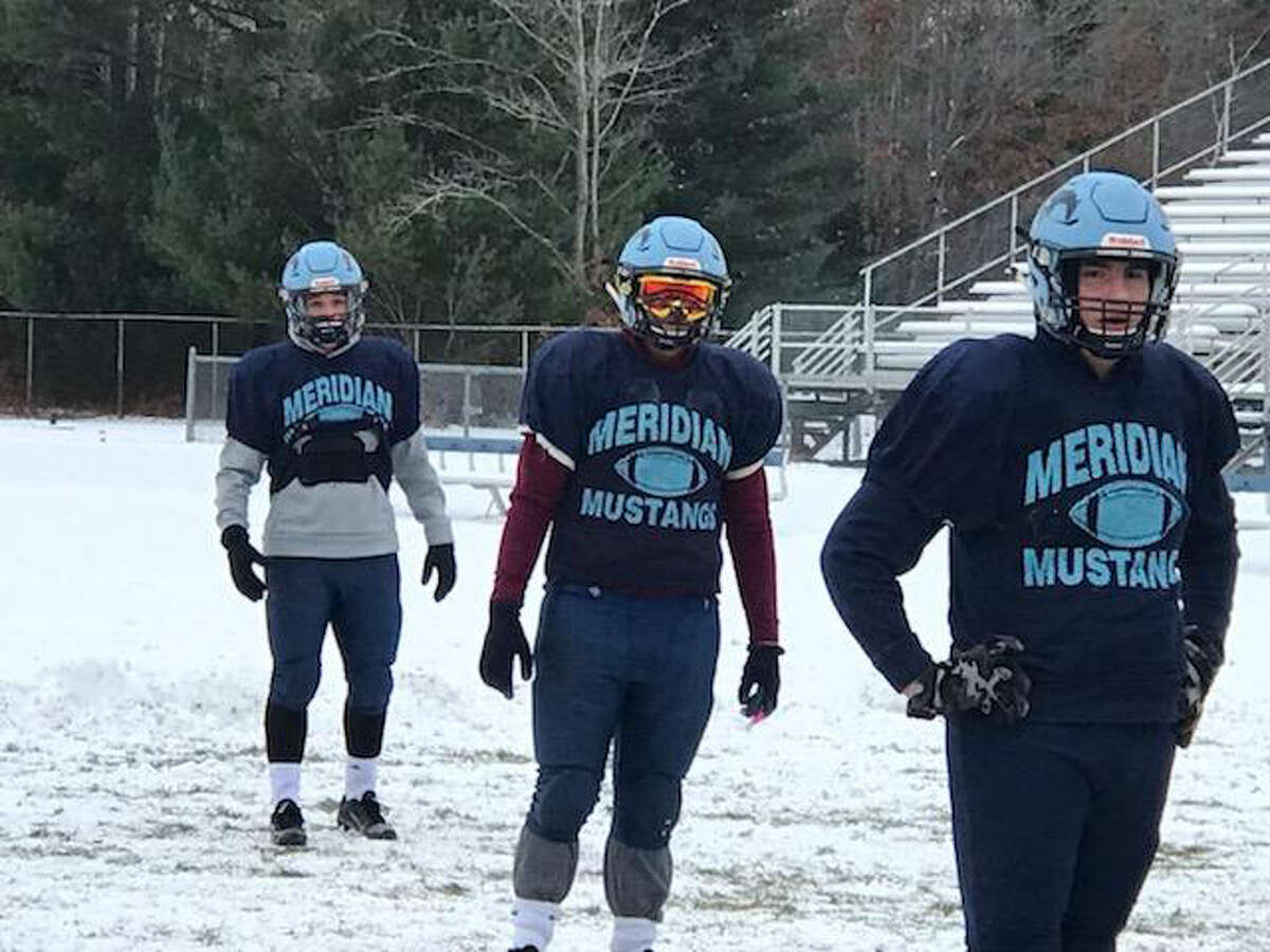 Meridian football players, from left, Brady Solano, Josh Barriger and Gabe Sturgeon are shown at practice at the Mustangs' field this week in preparation for Saturday's Division 6 regional final at Montague.