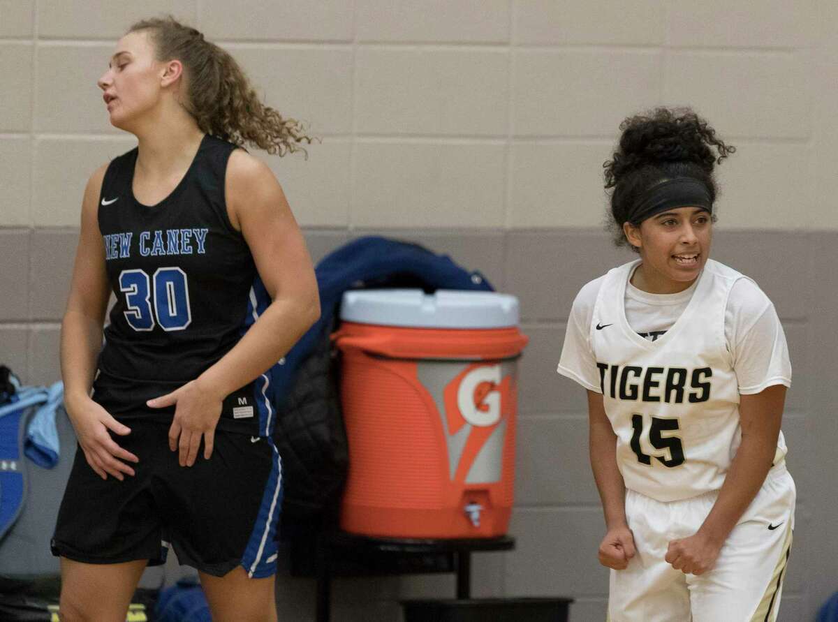 Conroe guard Daniela Galindo (15) reacts in front of New Caney power forward Abigail Lynch (30) after defeating the Lady Eagles 41-37 in overtime of a high school girls basketball game during the Lady Tiger Classic at Conroe High School, Thursday, Nov. 14, 2019, in Conroe.