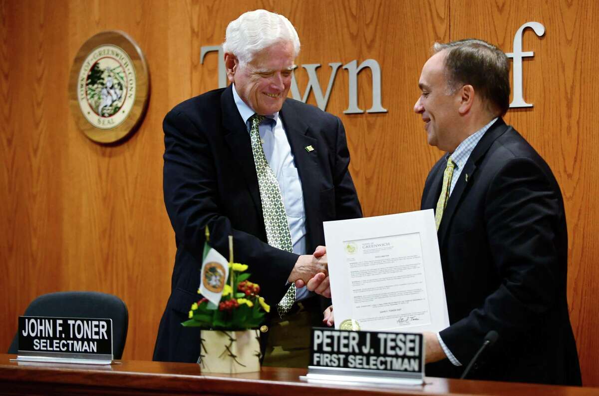 Greenwich First Selectman Peter Tesei, who has been in office for 12 years, right, honors Selectman John Toner with a proclamation during the current Board of Selectmen's last meeting Thursday, November 14, 2019, at Greenwich Town Hall in Greenwich, Conn.