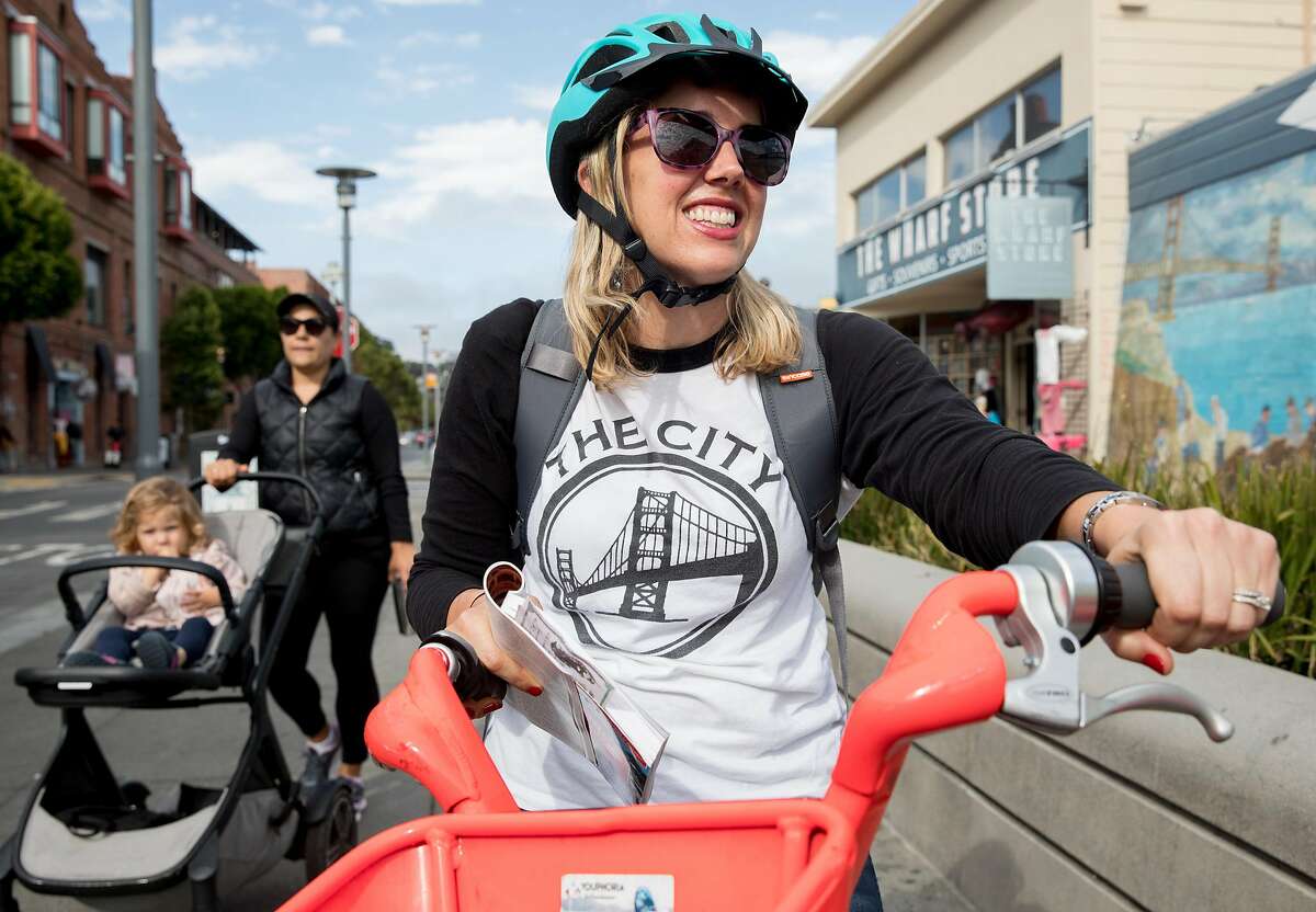 San Francisco Chronicle reporter Heather Knight gets on a JUMP bike along Jefferson Street in Fisherman's Wharf in San Francisco, Calif. Wednesday, September 4, 2019 as she and fellow reporter Peter Hartlaub attempt to traverse San Francisco�s 49-mile Scenic Drive without using a car.