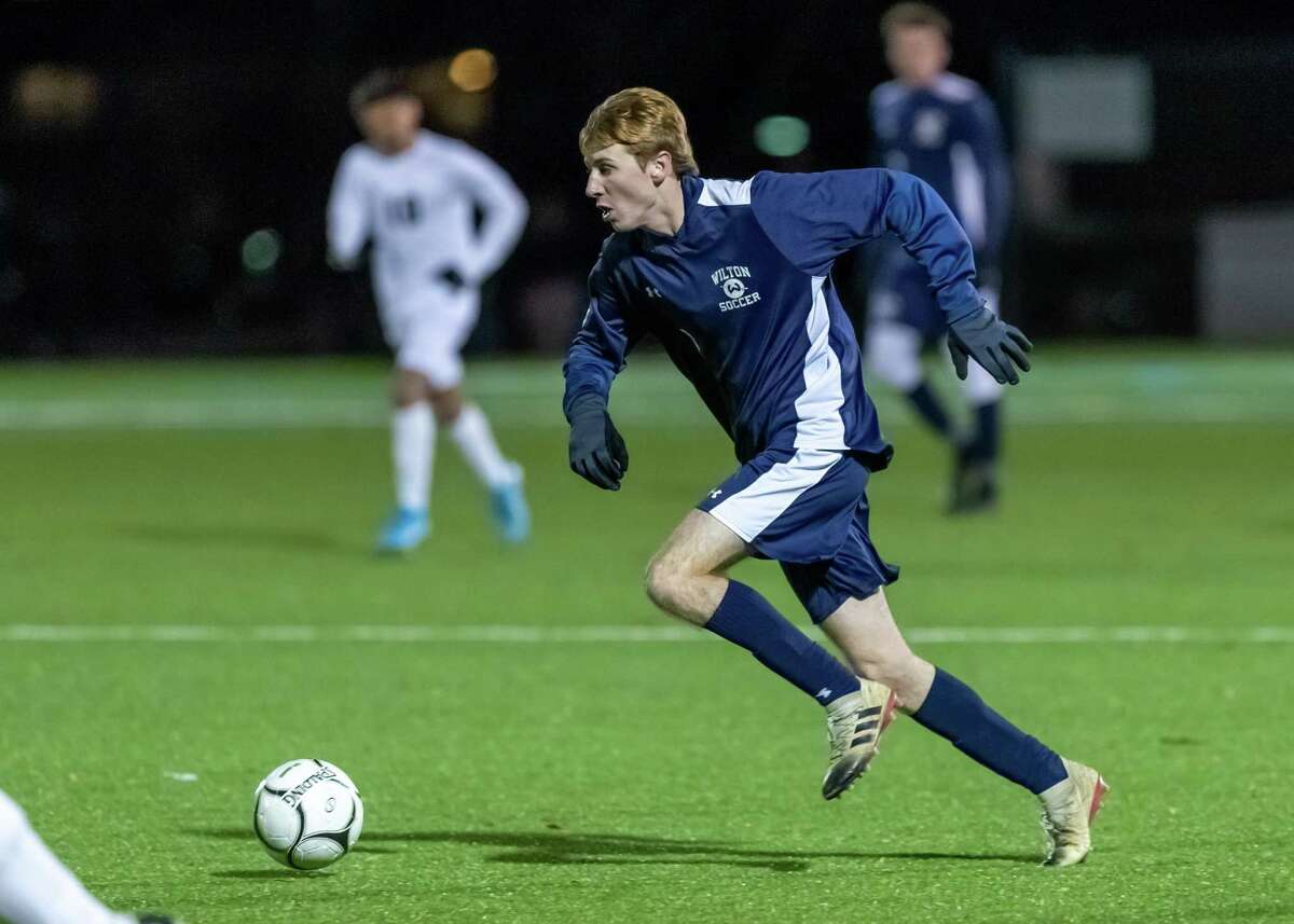 Liam McLaughlin dribbles toward the Maloney goal during Wednesday's state tourney game.