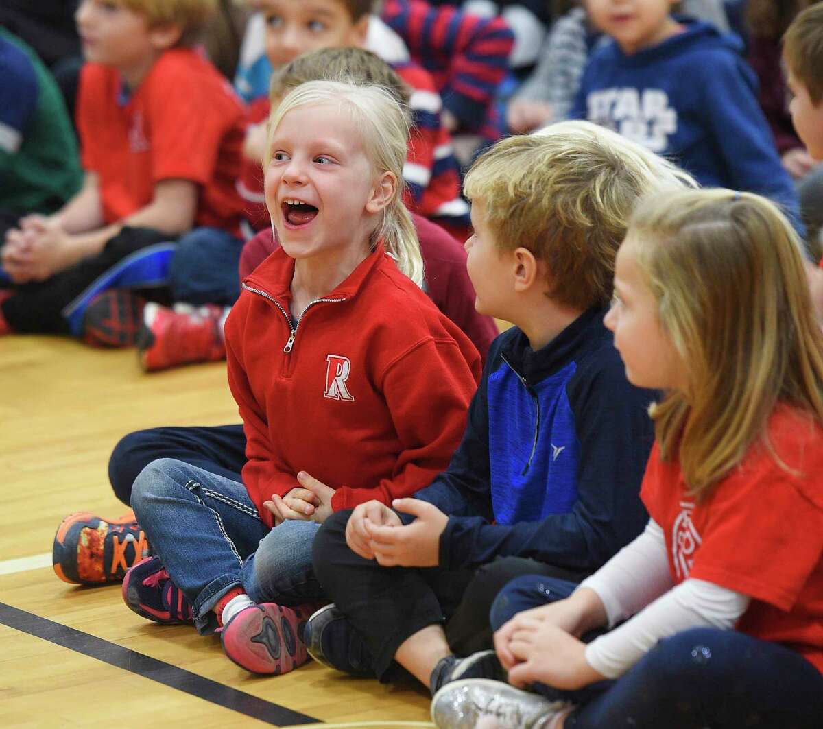 Kindergartner Rose Mund yells "thank you for your service" to veterans in attendance at the Veterans Day ceremony at Riverside School in the Riverside section of Greenwich, Conn. Friday, Nov. 9, 2018.