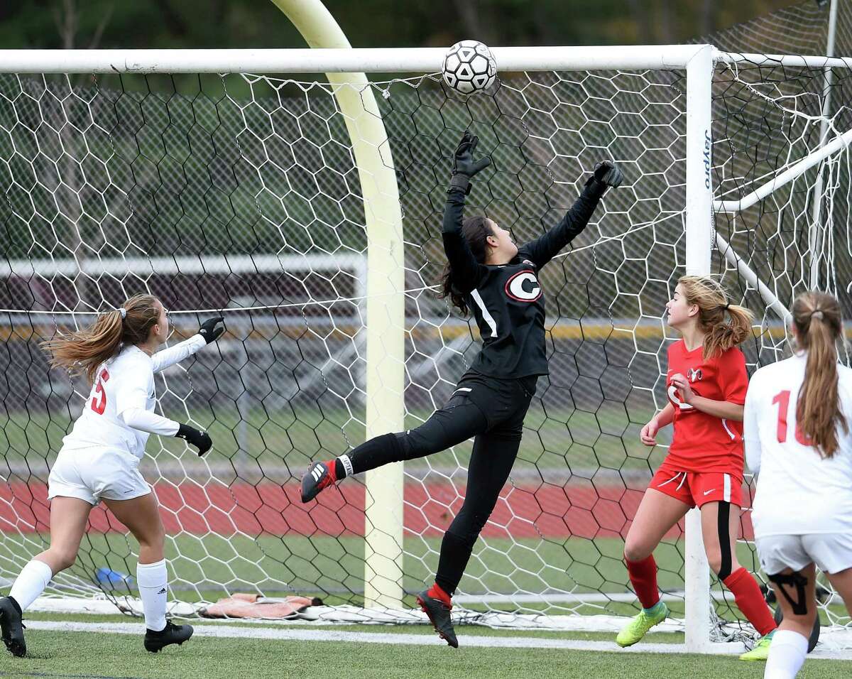 A shot from Dillyn Patten (not in photo) of New Canaan gets past Cheshire goalie Seymone Rosenberg on Thursday.