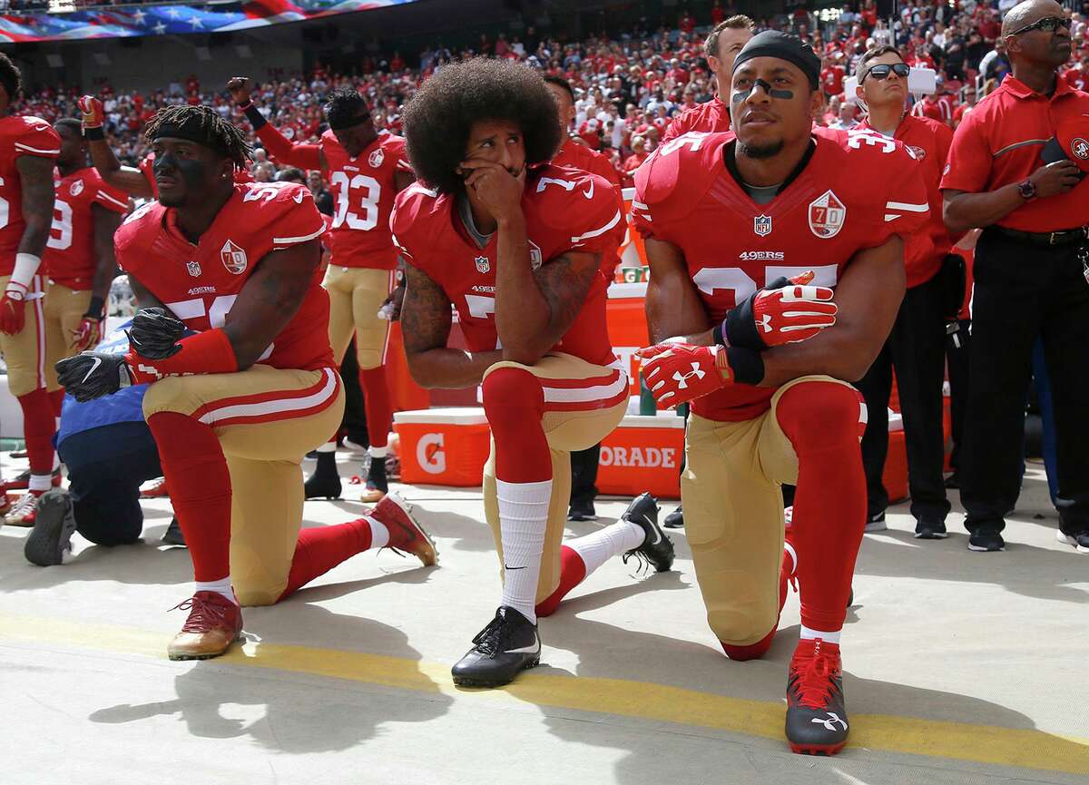 The San Francisco 49ers’ Eli Harold (58), Colin Kaepernick (7) and Eric Reid (35) kneel during the national anthem before a game against the Dallas Cowboys on Oct. 2, 2016, at Levi’s Stadium in Santa Clara, Calif.