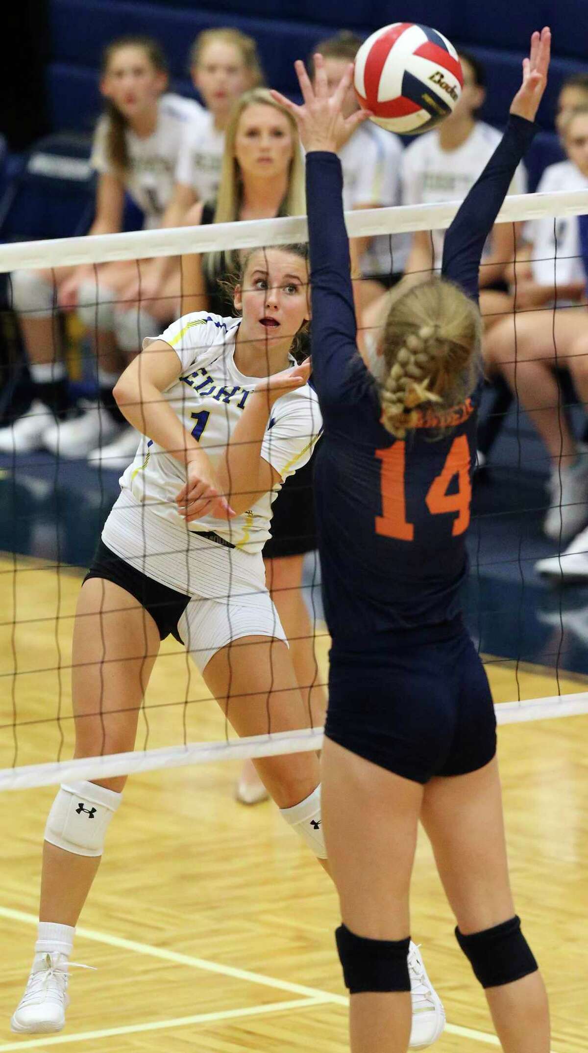Avery Rosenblum fires the ball for the Mules through Emma Halstead as Brandeis plays Alamo Heights at Taylor Field House on August 120, 2019.