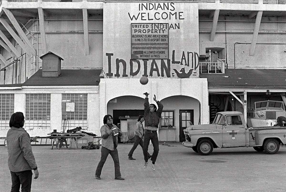 FILE--American Indians play ball games outside the prison wall on Alcatraz Island in San Francisco during their occupation of the island in this Nov. 26, 1969 file photo. The sign reading 'INDIANS WELCOME,' is one of the few physical reminders that 30 years ago a group of American Indians clung to the barren, bony slopes of Alcatraz for 19 months, winning the attention of the world and igniting a passion for civil rights. (AP Photo/File)