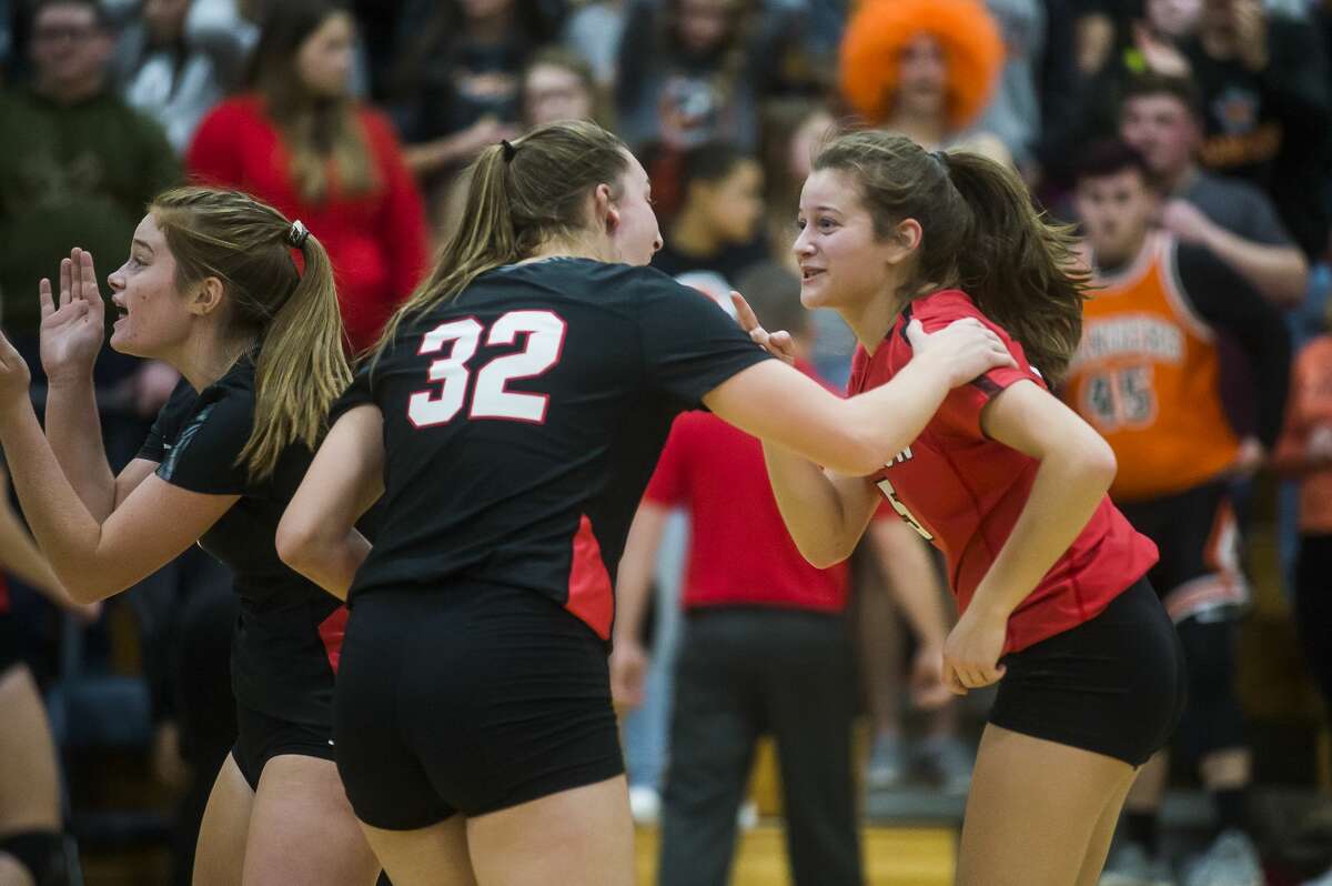 Beaverton's Macie Jerome, right, and Molly Gerow, left, celebrate after a point during the Beavers' Div. 3 regional final victory over Manton Thursday, Nov. 14, 2019 at Carson City-Crystal High School. (Katy Kildee/kkildee@mdn.net)