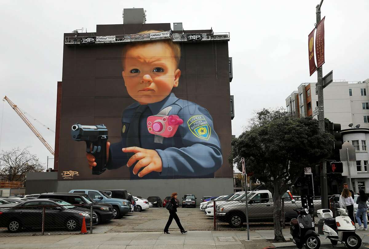 San Francisco muralist BiP's mural is located at 22 Franklin St., in San Francisco, Calif., on Thursday, November 14, 2019. He recently completed a mural with an image of a young boy, dressed in a police uniform, holding a gun. The controversial mural protests police brutality.