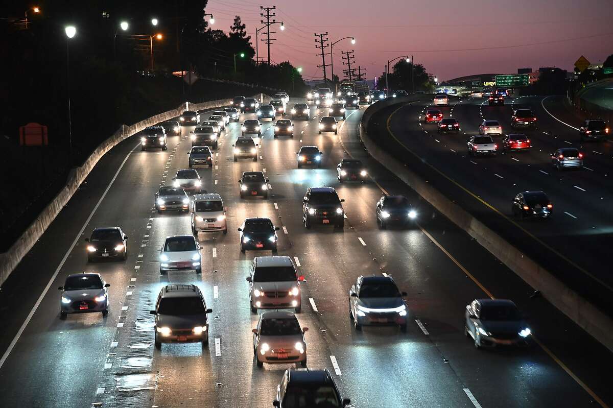 (FILES) In this file photo taken on September 17, 2019 motor vehicles drive on the 101 freeway in Los Angeles, California. - Carmaking heavyweights General Motors, Toyota and Fiat Chrysler have backed President Donald Trump's efforts to ban California from maintaining its own stricter standards on car emissions, the auto giants have confirmed. The announcement is the latest salvo in a months-long battle over car pollution between the White House and the US state, whose Democratic leaders have made fighting climate change a priority.The three automakers announced October 28, 2019 that they would support Washington in that legal action. (Photo by Robyn Beck / AFP) (Photo by ROBYN BECK/AFP via Getty Images)