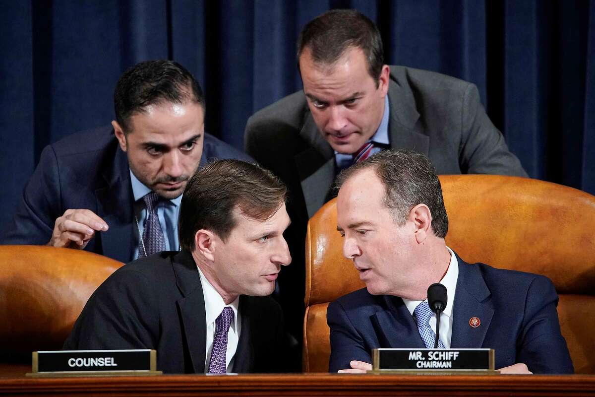 House Intelligence Committee Chairman Adam Schiff (R) (D-CA) speaks with Democratic Counsel Daniel Goldman (L) and other staffers during testimony from Marie Yovanovitch, former US ambassador to Ukraine, during a House Intelligence Committee hearing as part of the impeachment inquiry into US President Donald Trump on Capitol Hill in Washington, DC on November 15, 2019. (Photo by JOSHUA ROBERTS / POOL / AFP) (Photo by JOSHUA ROBERTS/POOL/AFP via Getty Images)