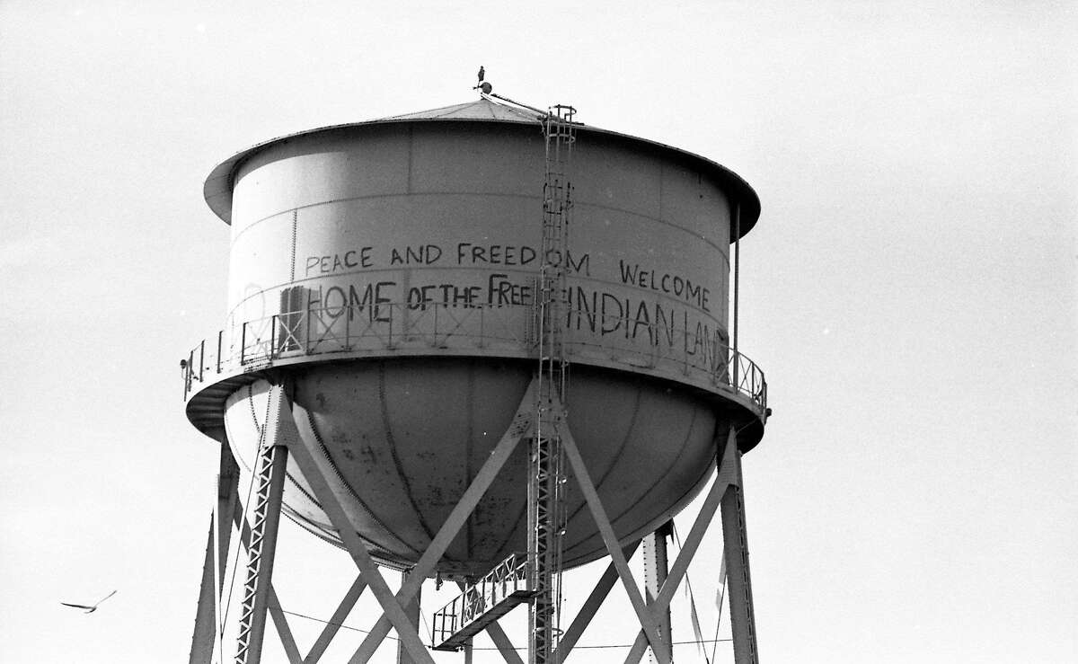 Undated: A seagull flies by a tower with pro-occupation messages during the Native American occupation of Alcatraz.