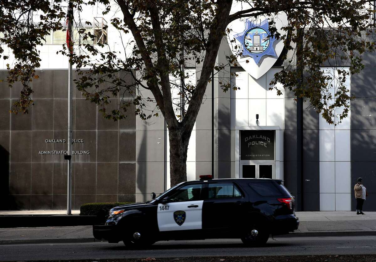 An Oakland police vehicle passes the Oakland Police Department, November 13, 2019.