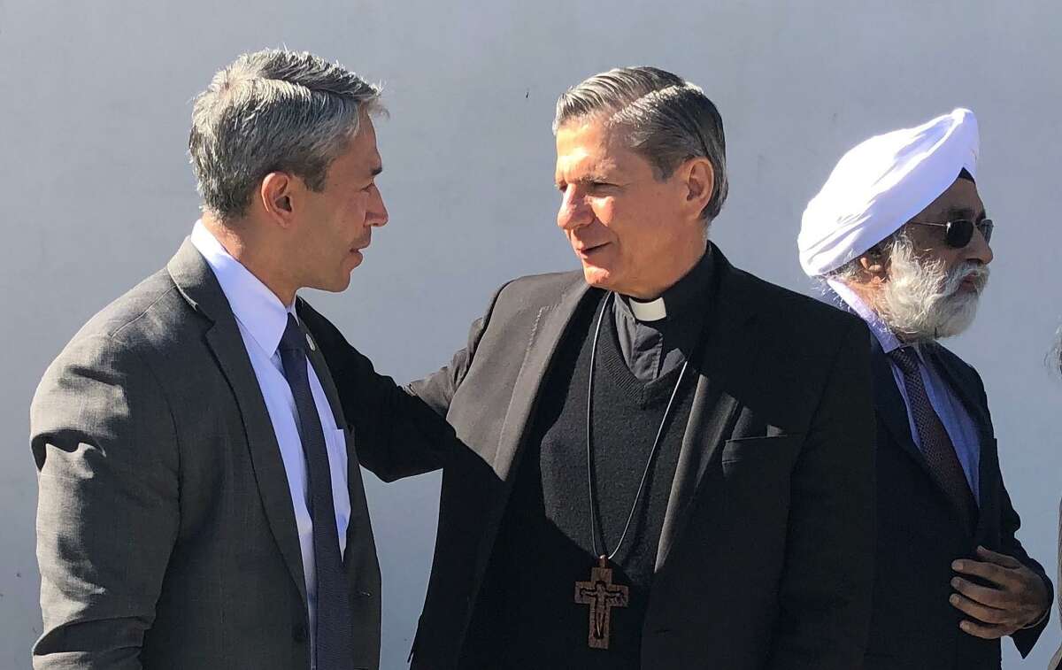 San Antonio Mayor Ron Nirenberg confers with Archbishop Gustavo García-Siller after religious community leaders and Interfaith San Antonio Alliance members signed a proclamation at Haven for Hope Chapel to improve the availability of affordable housing for the city's homeless.