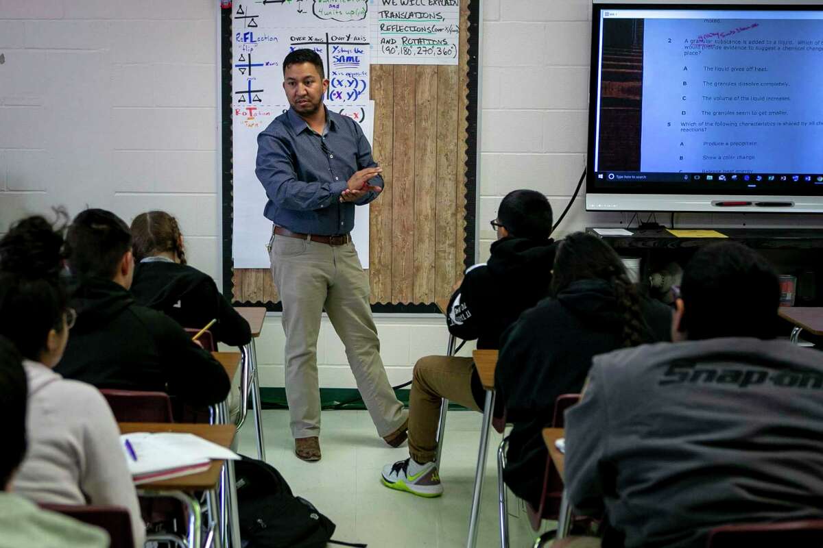 Eighth grade science teacher Adam Rodriguez addresses his students at Cotton Academy. Cotton has been named a high-performing high-poverty school by the Houston-based nonprofit Children at Risk for its middle school performance.