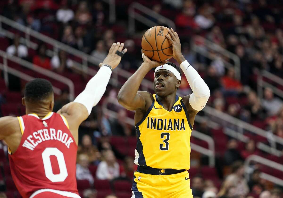 Indiana Pacers' Aaron Holiday (3) shoots as Houston Rockets' Russell Westbrook (0) defends during the first half of an NBA basketball game Friday, Nov. 15, 2019, in Houston. (AP Photo/David J. Phillip)