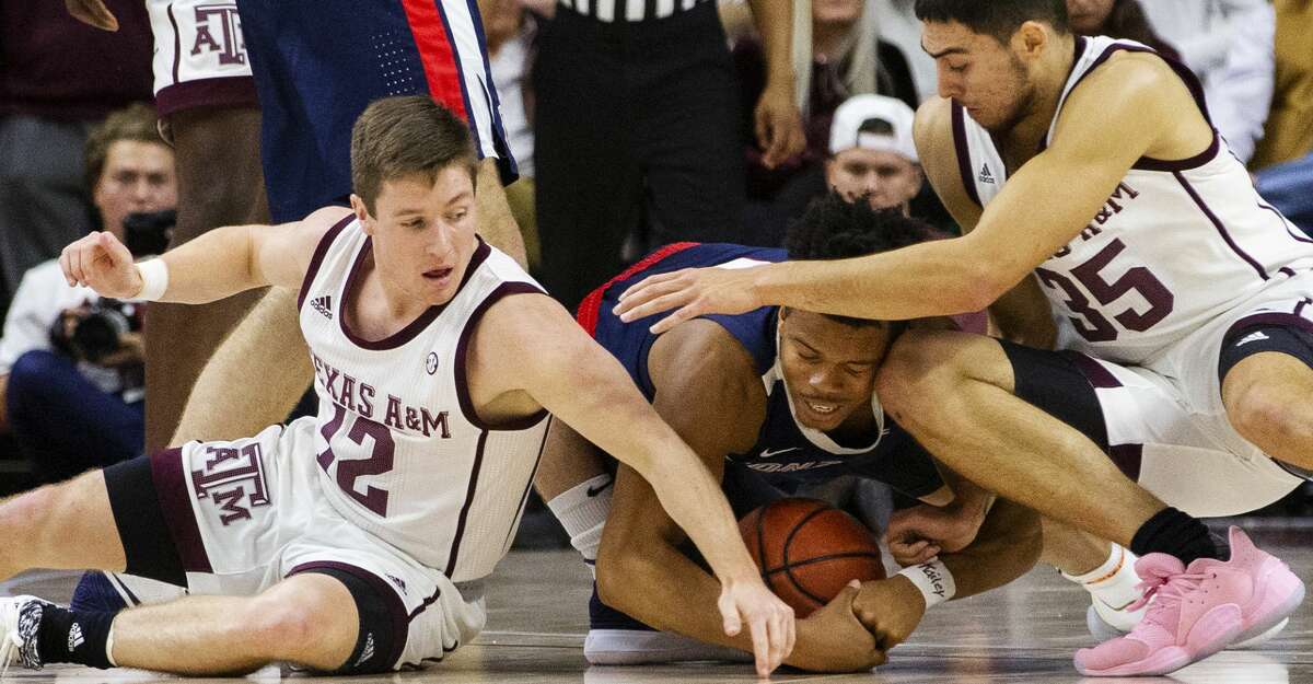 Gonzaga guard Admon Gilder (1) goes after a loose ball against Texas A&M guard Mark French (12) and Texas A&M forward Yavuz Gultekin (35) during the first half of an NCAA college basketball game Friday, Nov. 15, 2019, in College Station, Texas. (AP Photo/Sam Craft)