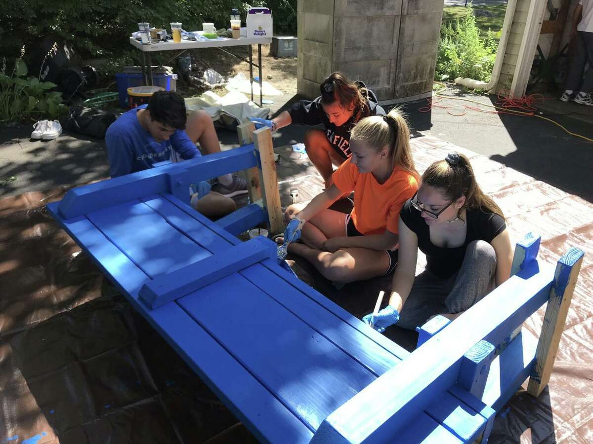 Volunteers and Round Table staff members Sophia Unmpierrez, Anistyn Boshka, Sophia Negyesi and Brayden Davis assist with the Buddy Benches.
