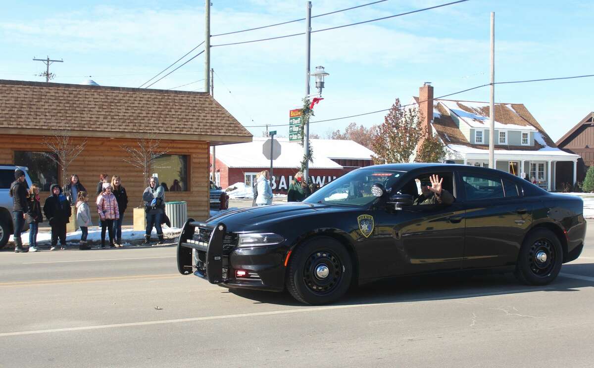Friends and families of all ages lined Michigan Avenue in Baldwin to ring in the holiday season with the annual Santa Parade on Saturday.