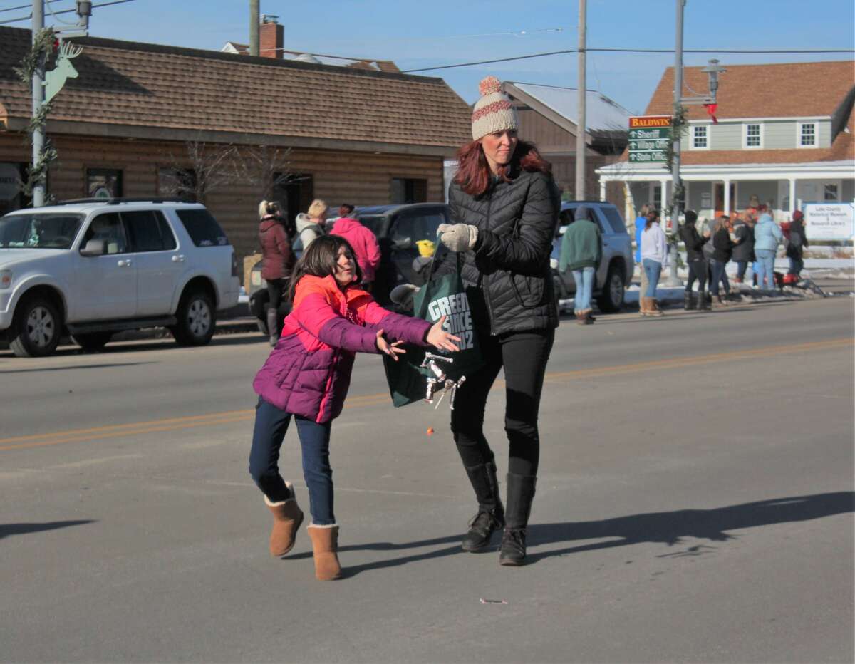 Friends and families of all ages lined Michigan Avenue in Baldwin to ring in the holiday season with the annual Santa Parade on Saturday.