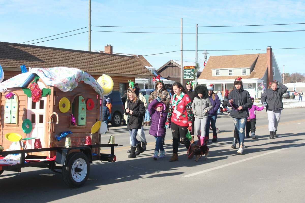 Friends and families of all ages lined Michigan Avenue in Baldwin to ring in the holiday season with the annual Santa Parade on Saturday.