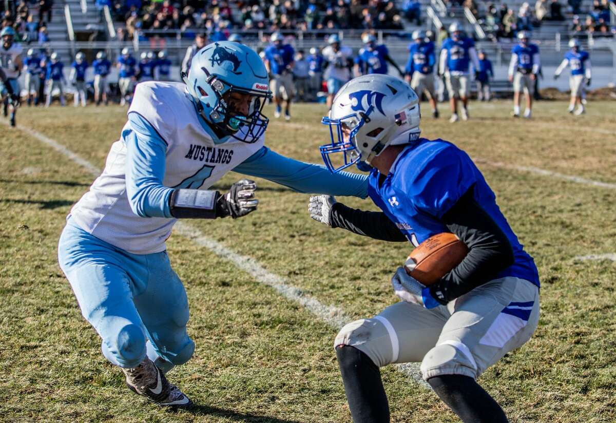 Meridian's Logan Crowder approaches the ball carrier during the Mustangs' 48-14 regionals loss to Montague Saturday, Nov. 16, 2019 at Montague High School. (Daytona Niles/for the Daily News)