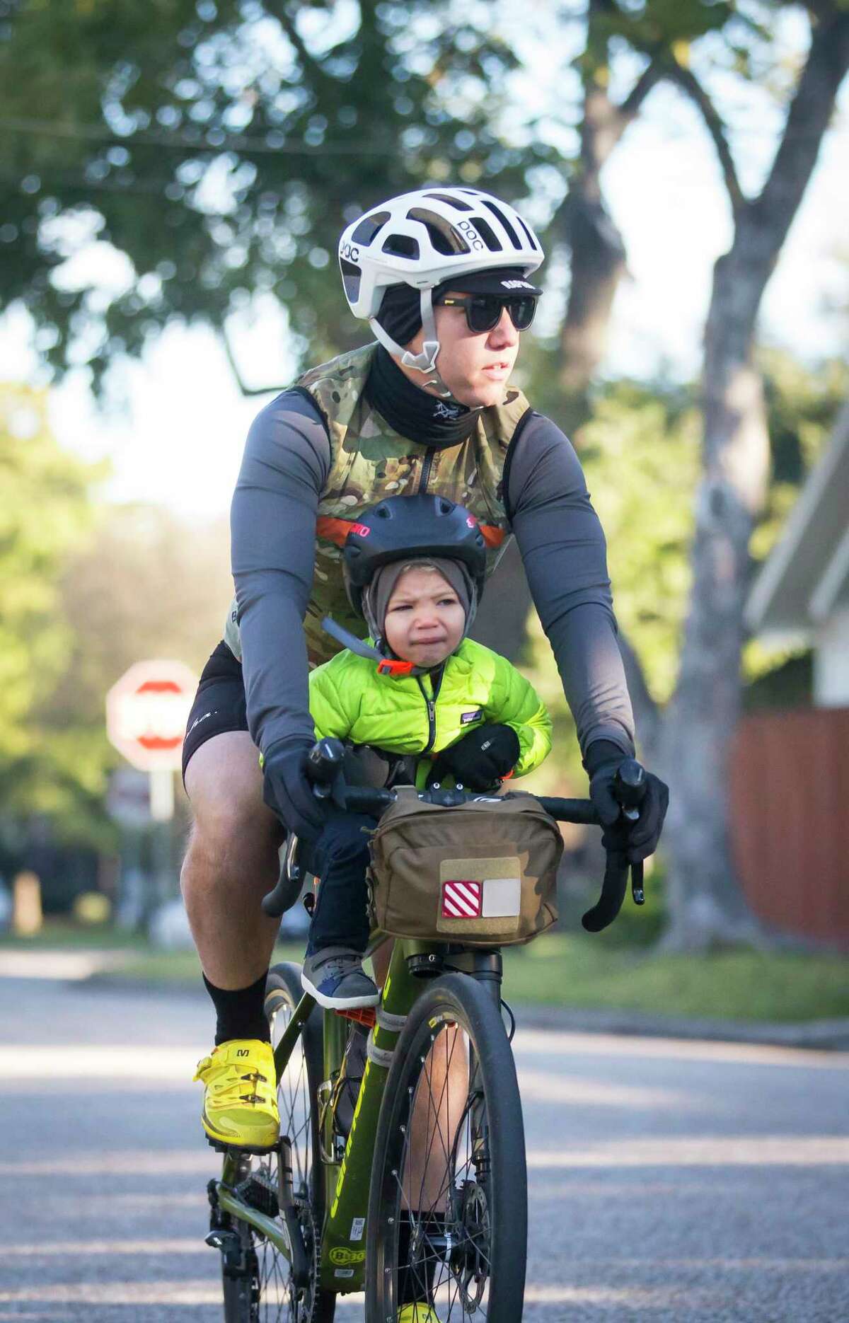 James Eilers rides with his 2.5-year-old son, Burton, during a morning group bike ride on Nov. 16, 2019, in the Heights. The family ride was organized by former pro cyclist Phil Gaimon and hosted by the Bicycle Speed Shop and Gaimon’s sponsor, Integrated Informatics Inc.