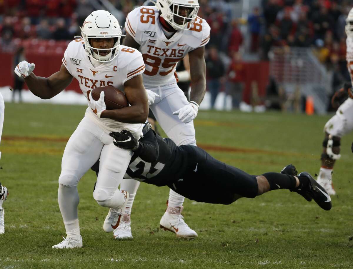 AMES, IA - NOVEMBER 16: Wide receiver Devin Duvernay #6 of the Texas Longhorns is tackled by defensive back Greg Eisworth #12 of the Iowa State Cyclones as he rushed for yards in the first half of play at Jack Trice Stadium on November 16, 2019 in Ames, Iowa. (Photo by David Purdy/Getty Images)