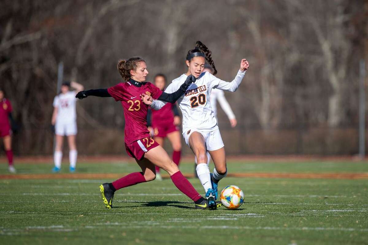 St. Joseph's Julia DiCesare (left) and Ridgefield's Julia Bragg battle for the ball during Ridgefield's 2-1 Class LL state quarterfinal win on Nov. 16, 2019.