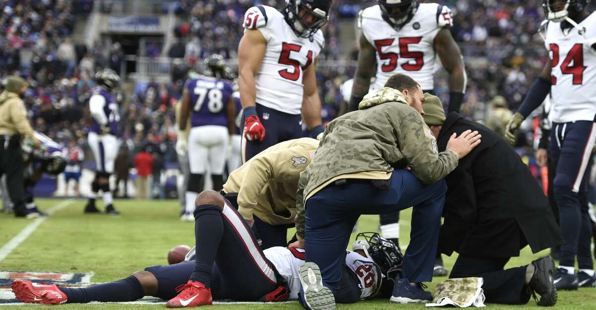 Trainers tend to Houston Texans strong safety Justin Reid (20) during the second half of an NFL football game against the Baltimore Ravens, Sunday, Nov. 17, 2019, in Baltimore. (AP Photo/Gail Burton)