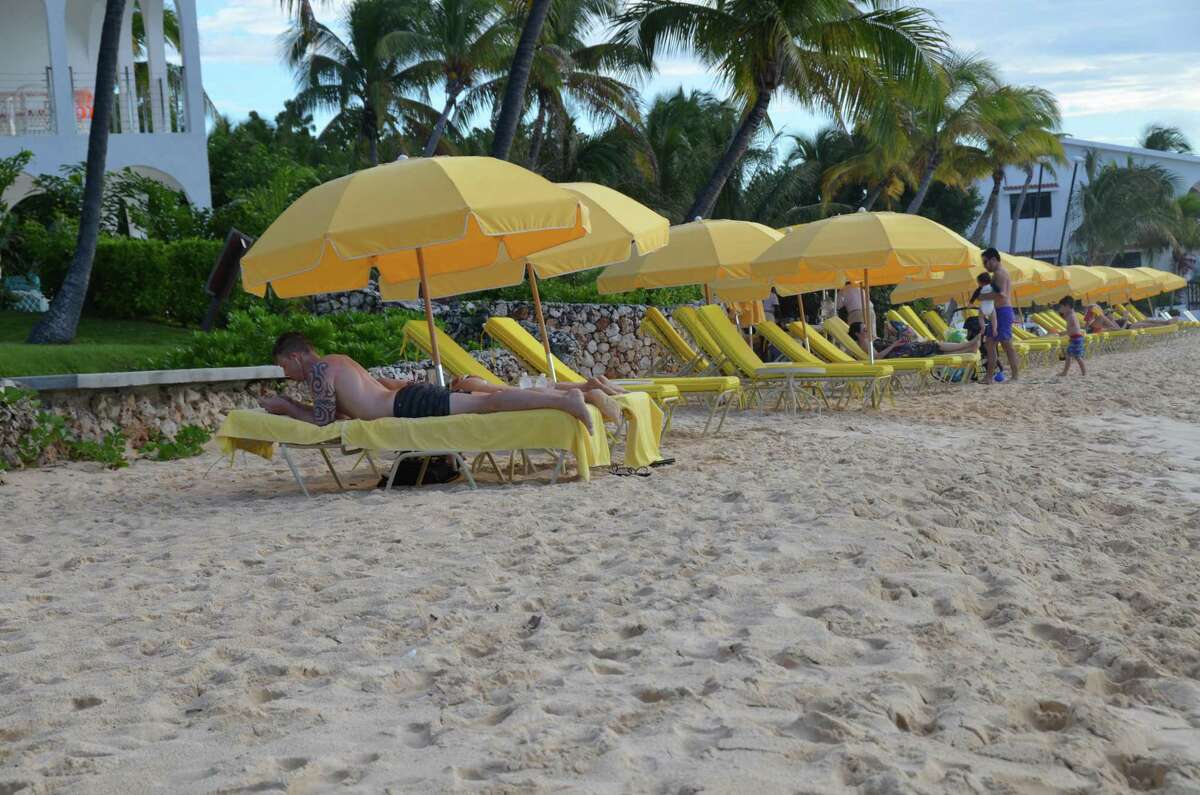 Tourists enjoy the beach on the Caribbean island of Anguilla on Sunday.