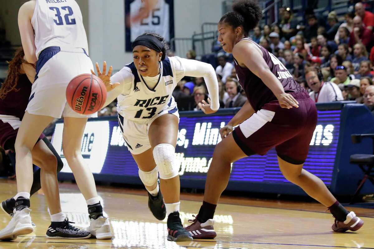 Rice guard Erica Ogwumike (13) reaches for the ball in front of Texas A&M center Ciera Johnson, right, during the second half of an NCAA college basketball game Sunday, Nov. 17, 2019, in Houston.